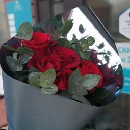Яркий букет с ароматными розами и эвкалиптом в упаковке